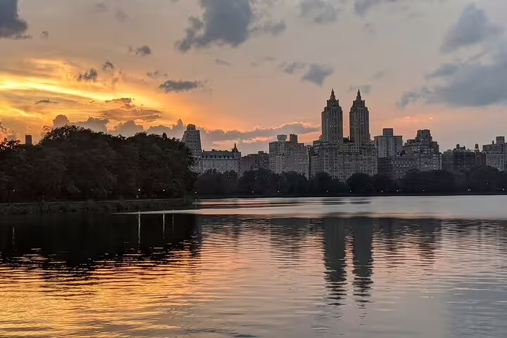 Central Park reservoir at sunset with NYC skyline reflecting on calm water