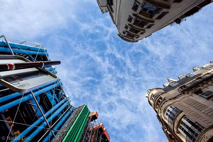 Upward view of Centre Pompidou exterior pipes and Paris buildings, on a 90-minute private guided tour in Paris