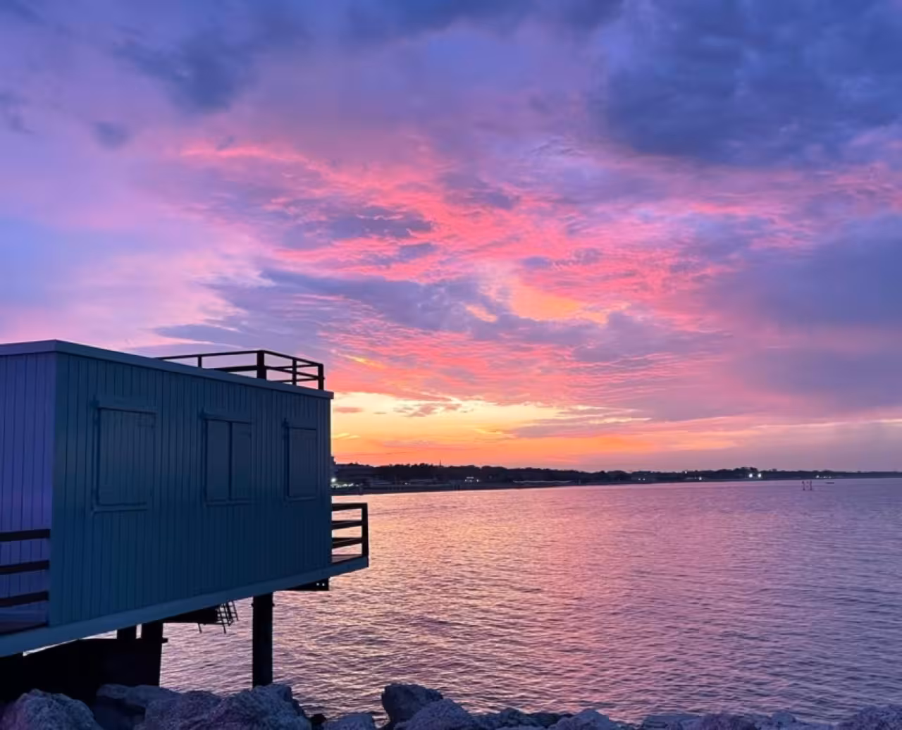 Pink sunset over Adriatic Sea from Cesenatico, scenic view on Riviera Romagnola afternoon boat tour
