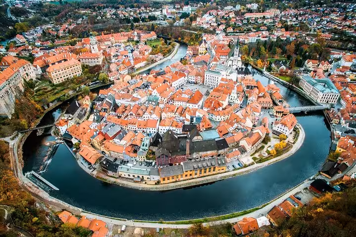 Aerial view of Cesky Krumlov UNESCO old town and Vltava River bend, highlight of private tour from Salzburg