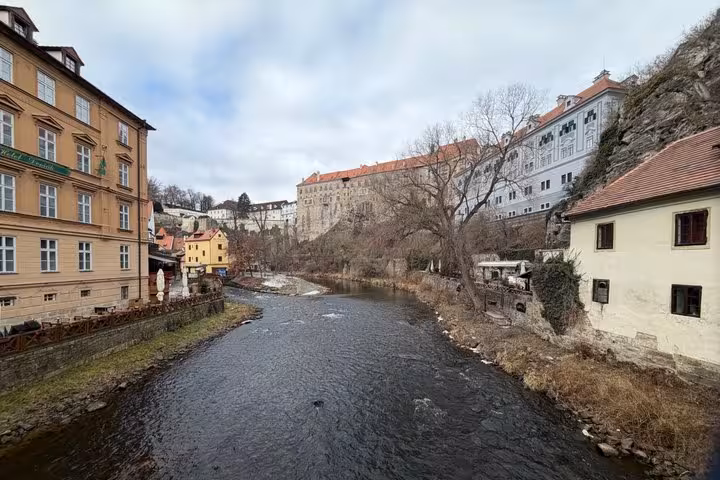 Vltava River and Cesky Krumlov riverside houses, scenic stop on Vienna to Prague private transfer