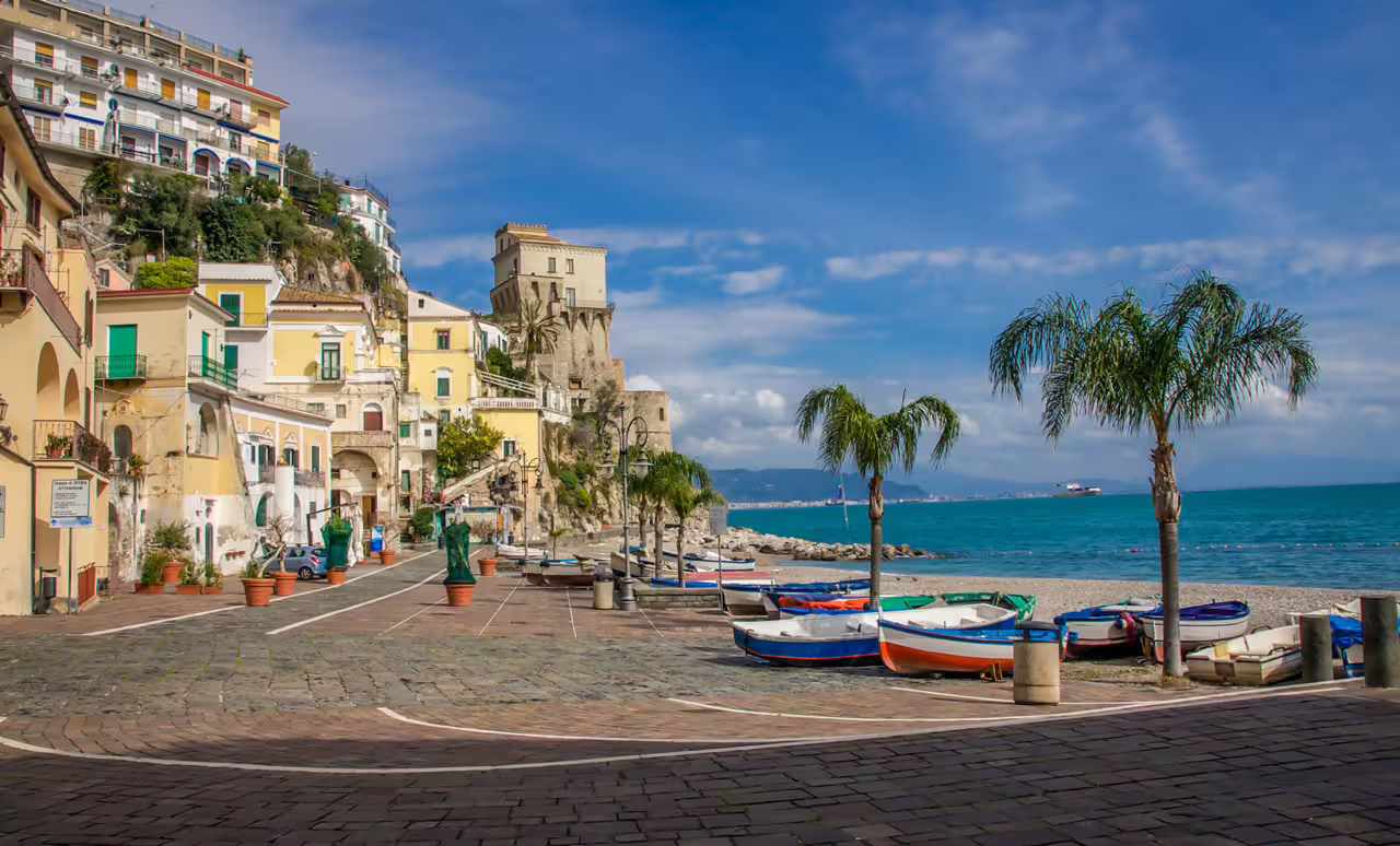 Cetara seaside promenade with fishing boats and palm trees, private Amalfi Coast day trip from Sorrento