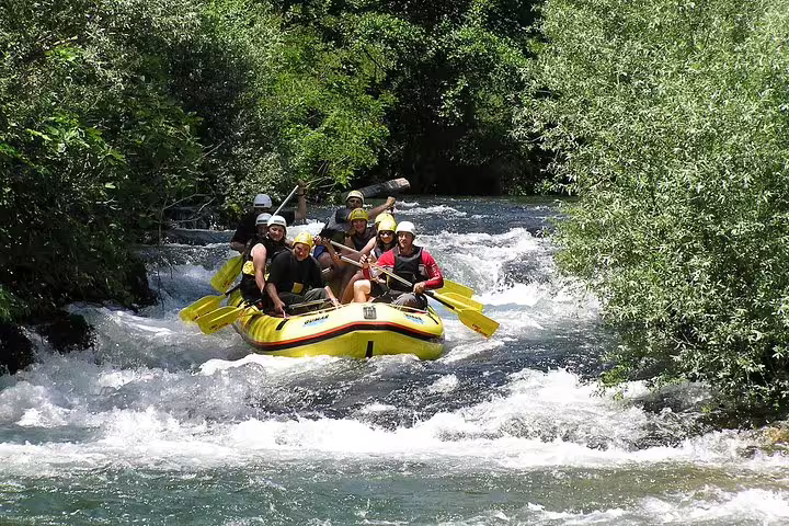 Cetina River rafting tour from Makarska Riviera, team in yellow raft navigating fast rapids, transfer included