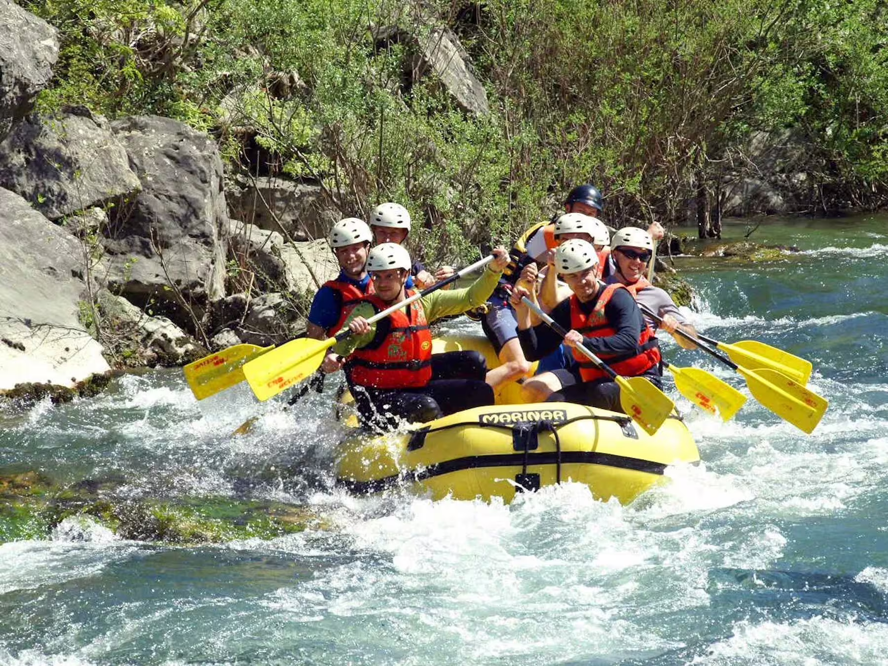Cetina River whitewater rafting tour from Makarska Riviera with transfer, yellow raft navigating rocky rapids