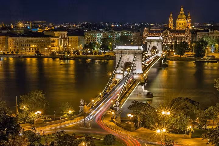 Chain Bridge lit up over the Danube in Budapest at night, iconic stop on a private day trip from Vienna