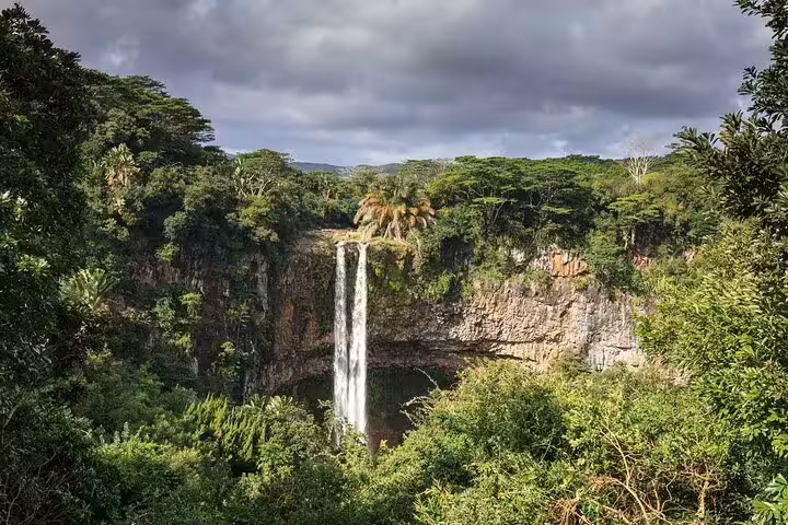 Twin streams of Chamarel Waterfall framed by rainforest cliffs, highlight of a private South Mauritius adventure