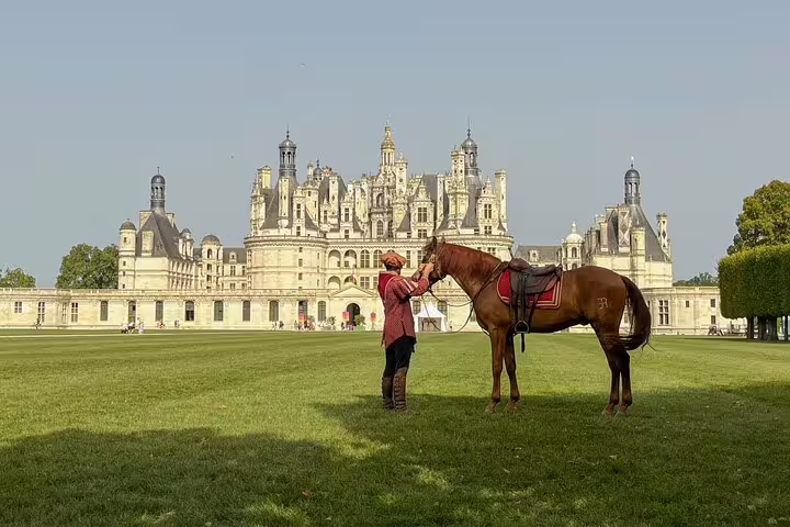 Château de Chambord visit in Loire Valley with horse and rider on lawn, part of wine tasting day tour