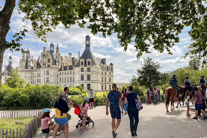 Visitors stroll toward Château de Chambord on a Loire Valley wine tour with castle visit and lunch