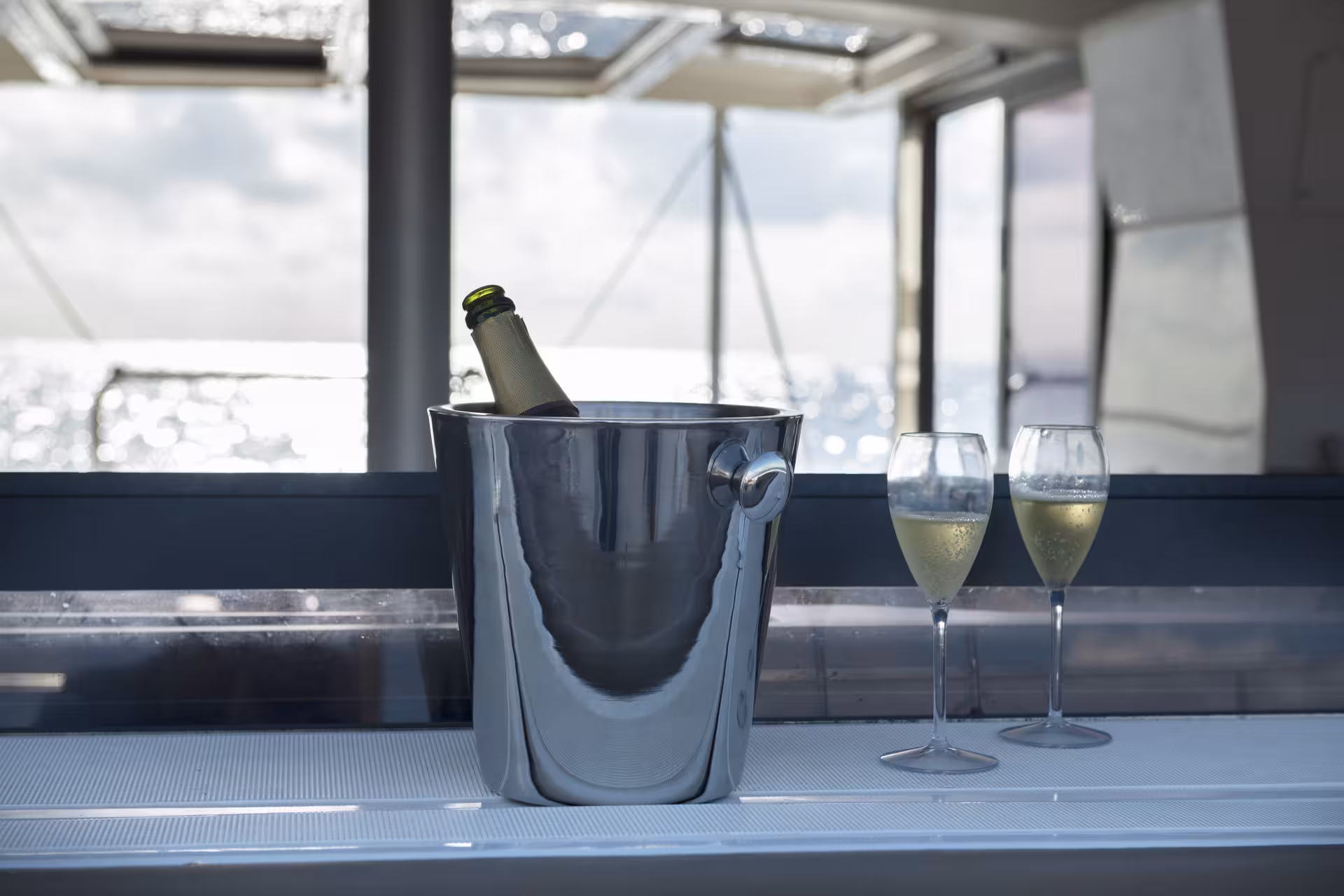 Champagne on ice with two flutes on a luxury yacht, perfect for a romantic marriage proposal cruise