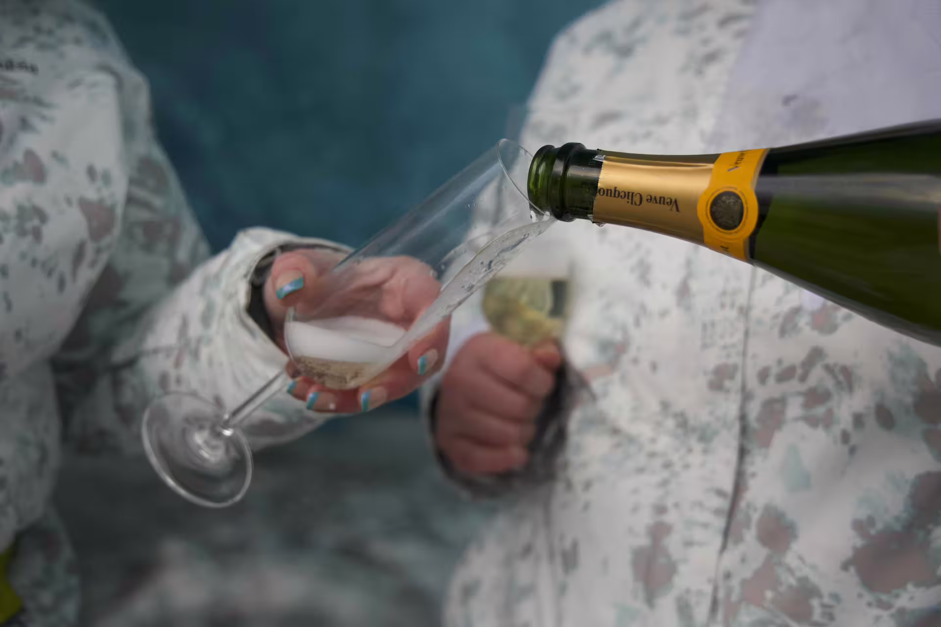 Champagne being poured into a flute during a private glacier engagement celebration tour