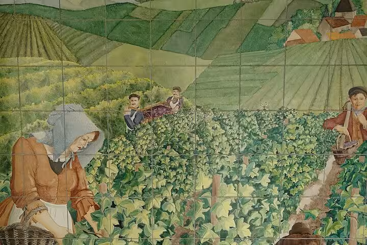 Ceramic tile mural depicting vineyard workers harvesting grapes in the Champagne region of France