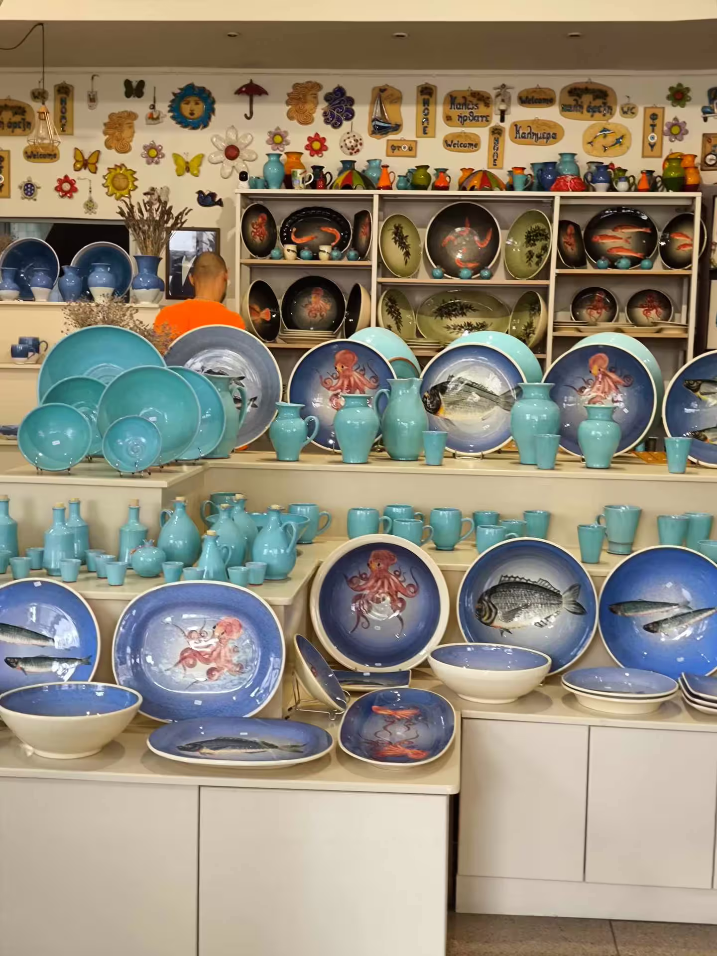 Colorful ceramic plates and pottery featuring marine designs at a local artisan shop in Chania, Crete.