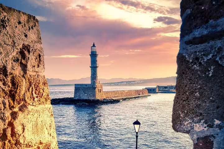 Captivating sunset at Chania Lighthouse, highlighting the historic charm on a private tour from Rethymno.