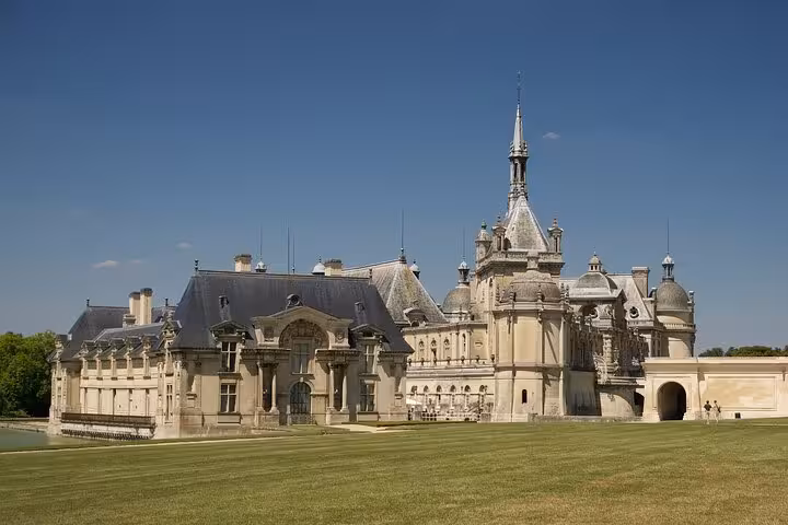 Chantilly Castle exterior and manicured lawns on a private guided tour, a top day trip from Paris, France