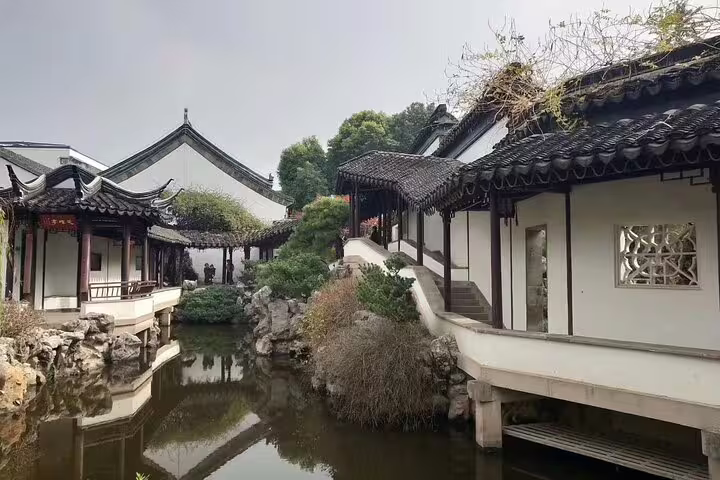 Traditional Chinese architecture reflected in a serene pond at Chaotian Palace, Nanjing day tour highlight.