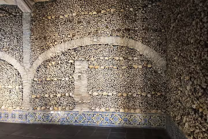 The Chapel of Bones in Évora, Portugal, displays walls adorned with human skulls and bones for a unique historical experience.