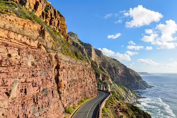 Scenic coastal drive along Chapman's Peak, offering breathtaking views on the Table Mountain National Park tour.
