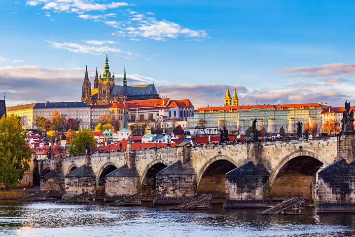 Charles Bridge and Prague Castle overlooking the Vltava River on a sunny day