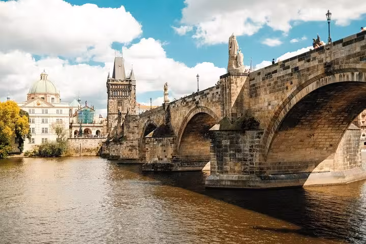 Charles Bridge with baroque statues spanning the Vltava River with Old Town Bridge Tower in Prague