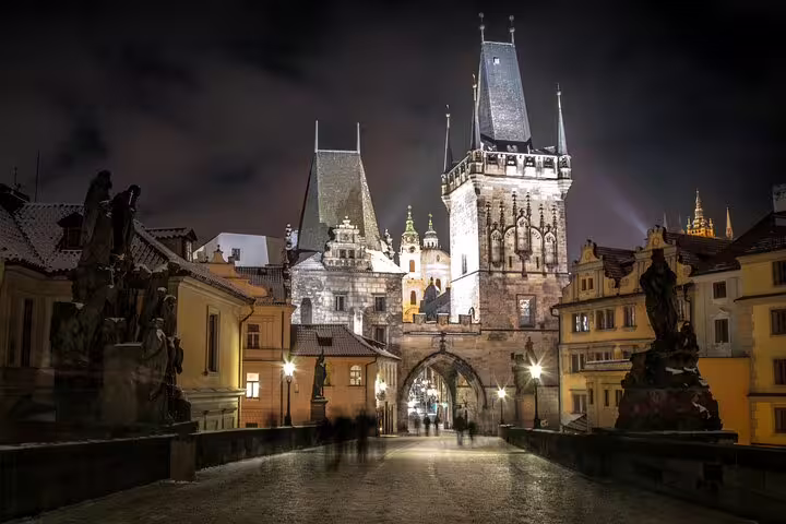 Charles Bridge and Lesser Town Bridge Tower illuminated at night in Prague