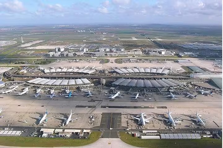 Aerial view of Paris Charles de Gaulle Airport terminals and aircraft, book private airport transfer to central Paris