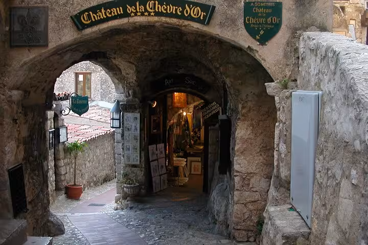 Stone archway entrance to Château de la Chèvre d'Or in a medieval village on the French Riviera