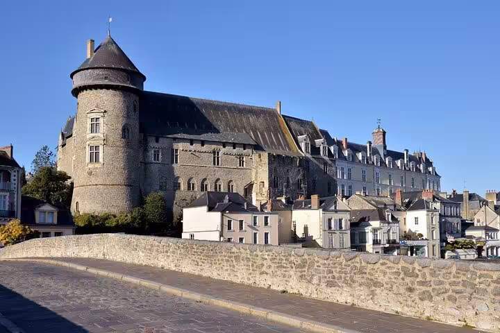 Medieval Château de Laval with round tower and stone walls overlooking the old town in France