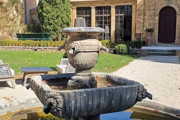 Historic fountain courtyard at Château La Gaude, elegant Provence setting on Wine Elegance wine tour