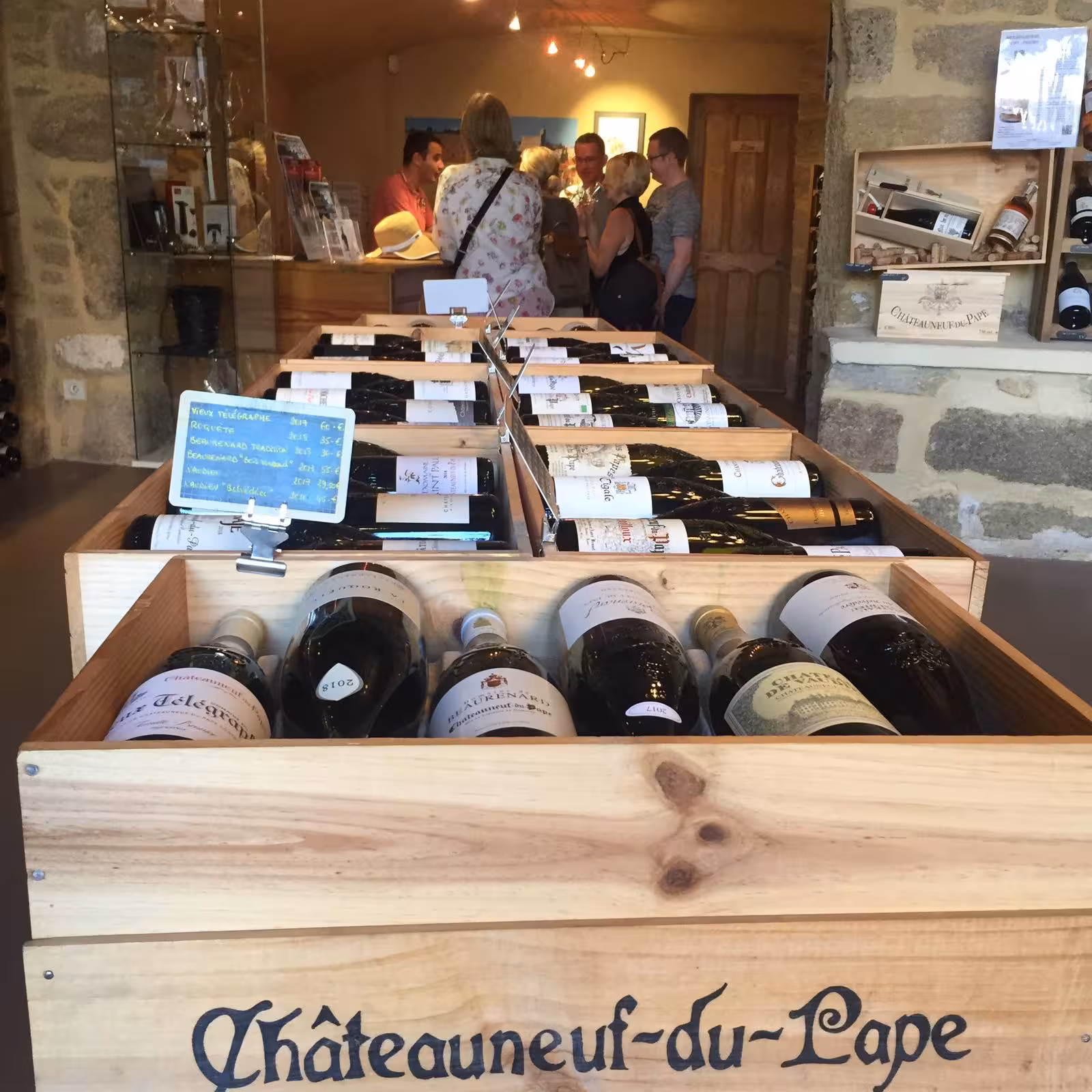 Châteauneuf-du-Pape wine shop cellar with bottles in wooden crates, stop on Avignon wine tasting tour