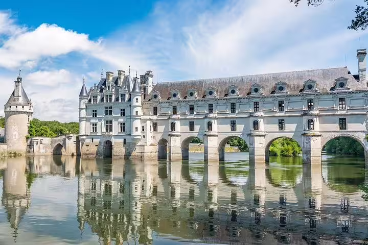 Château de Chenonceau spanning the River Cher, highlight of Loire Valley castles tour with lunch and vineyard