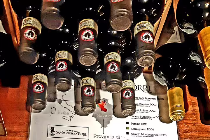 Bottles of Chianti Classico DOCG wine on display above a Tuscany map during a guided tasting on a San Gimignano tour