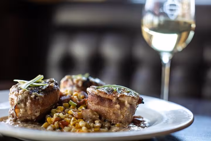 Delicious gourmet dish paired with white wine during Chianti dinner experience.