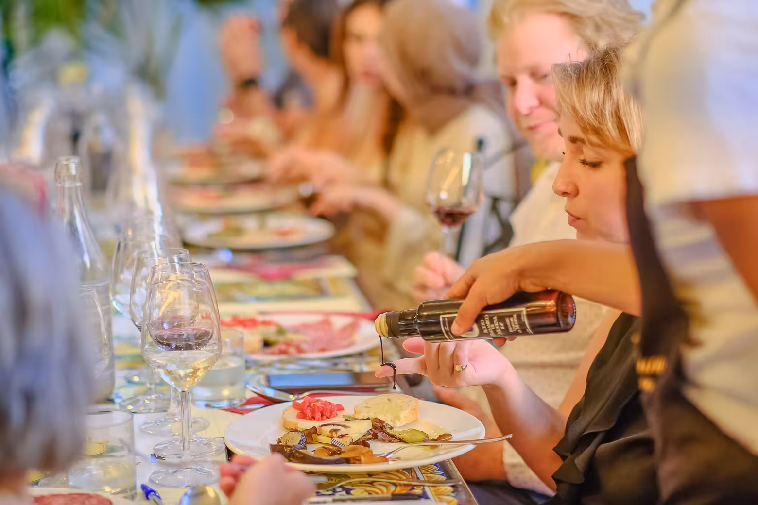 Guests enjoying a gourmet dinner paired with wine on the Siena and Chianti Wine Tour from Florence.