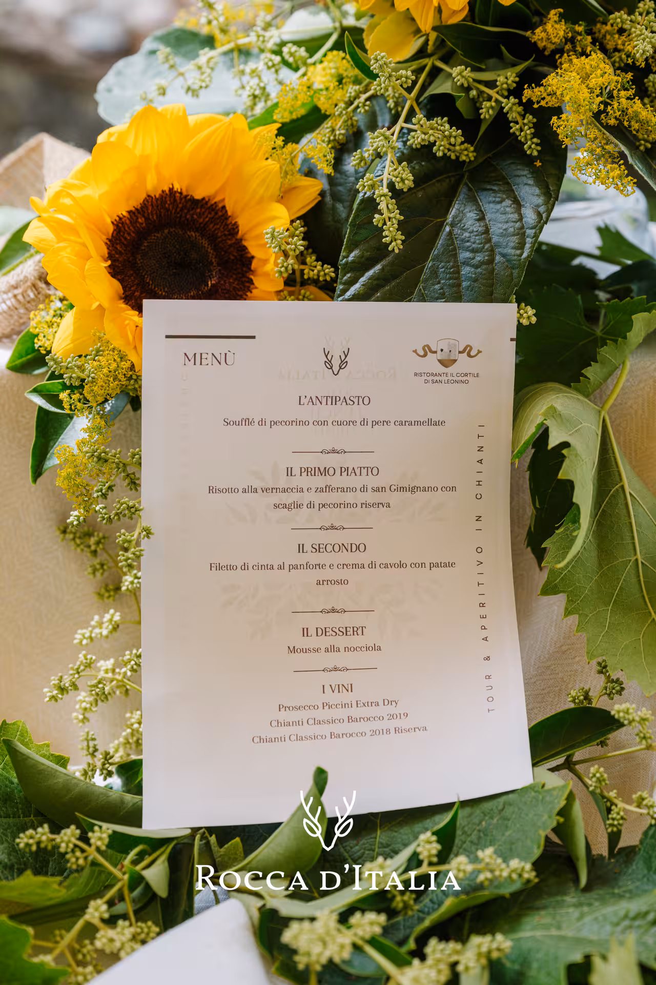 Italian restaurant menu for Chianti wine tasting tour with sunflower floral arrangement at Ristorante Il Cortile di San Leonino