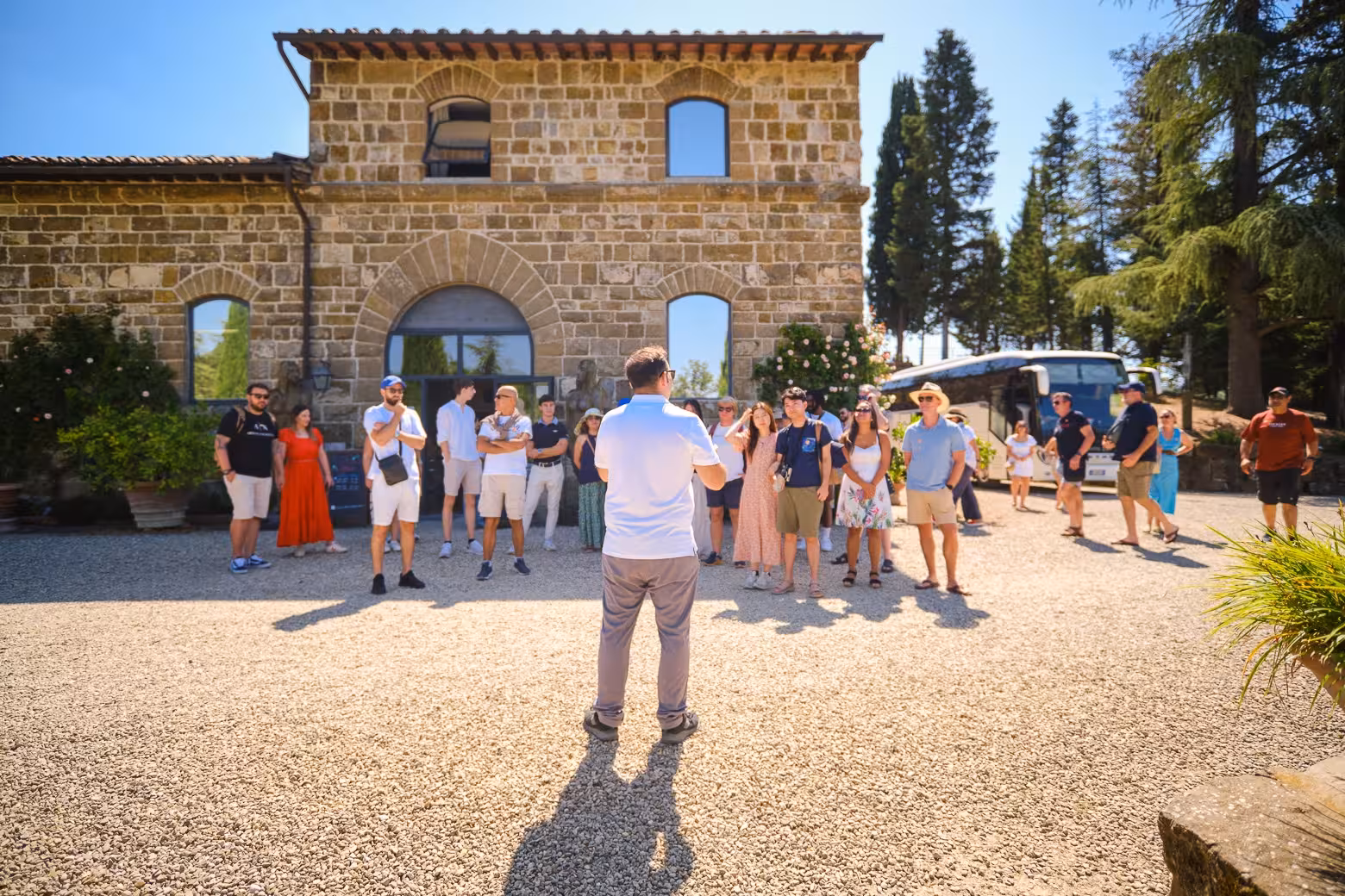 Tour group gathers outside a rustic villa in Chianti, Tuscany, ready for wine tasting adventures.
