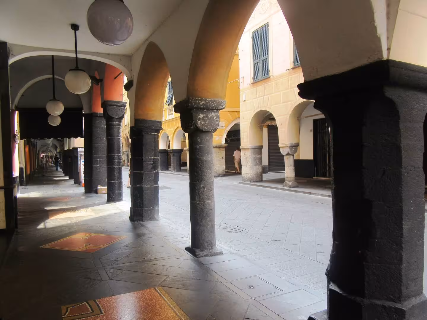 Charming covered arcades in the historic center of Chiavari, perfect for exploring during a local food and aperitif tour.