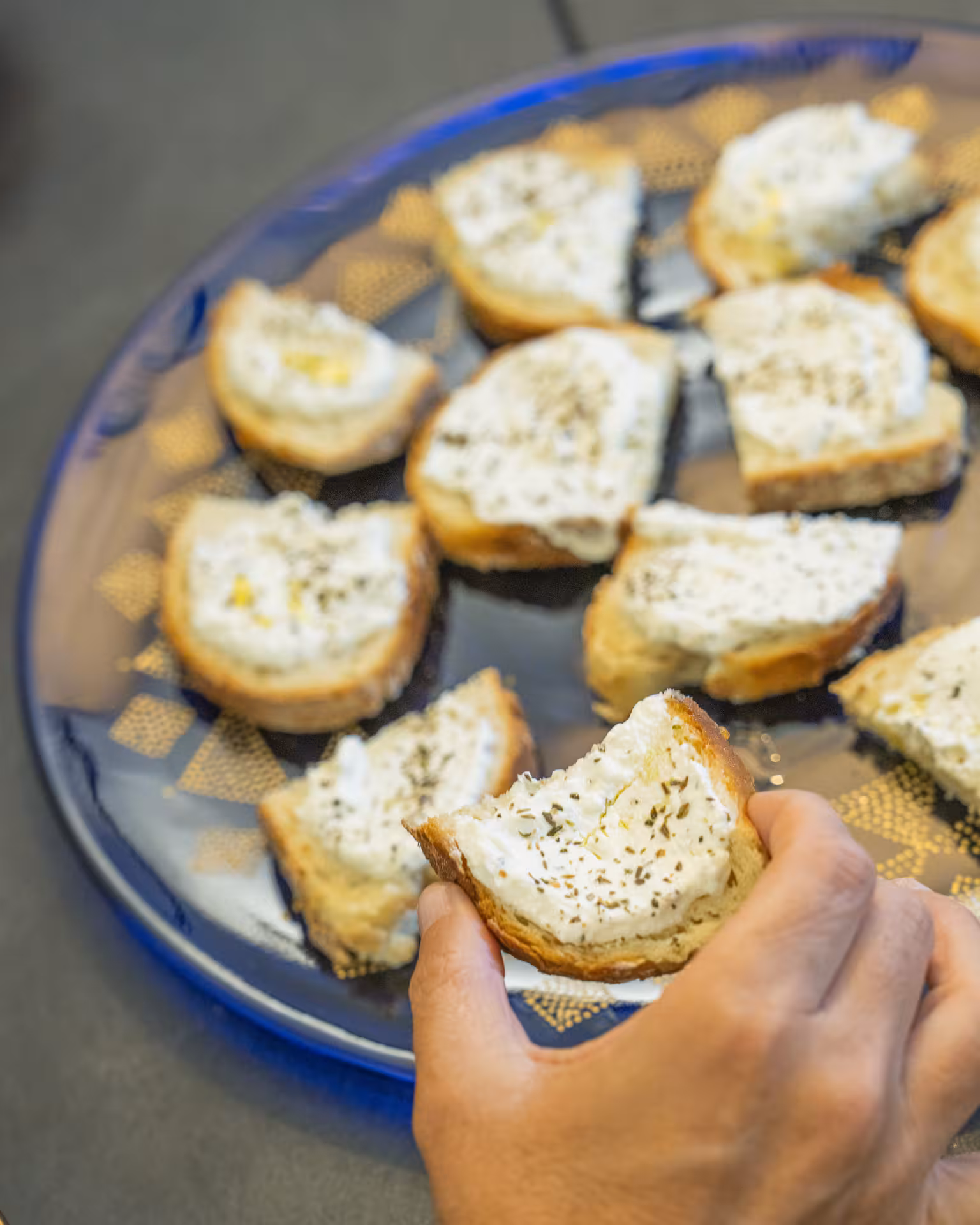 Hand holding crostini with creamy topping, highlighting local Chiavari flavors on an Italian food tour.