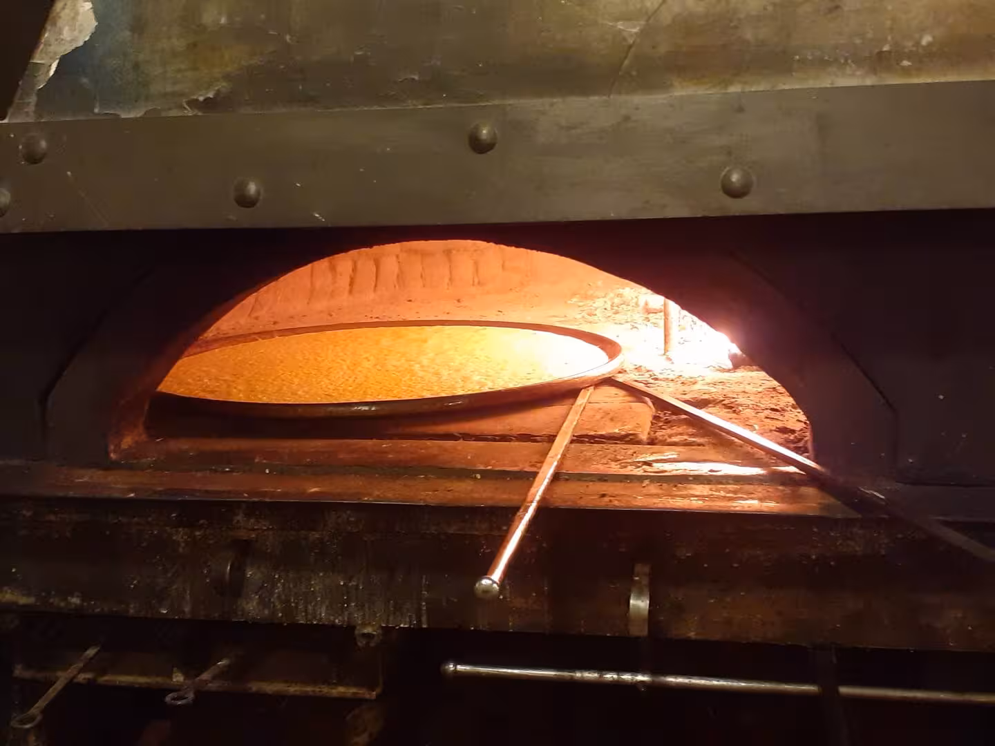 Traditional wood-fired oven baking focaccia, a highlight of Chiavari's culinary food tour experience.