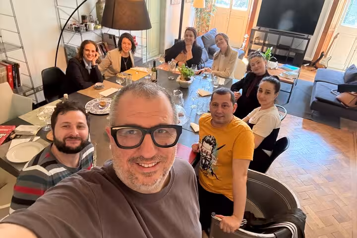 Group of people enjoying a cozy aperitif gathering in a stylish Chiavari setting, part of a local food tour.