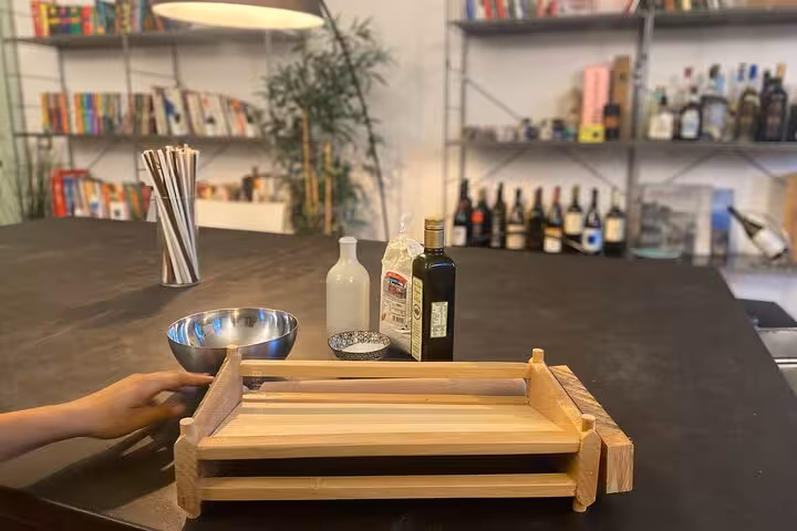 Preparation table for a Chiavari food tour, featuring olive oil and local ingredients ready for an Italian aperitif.