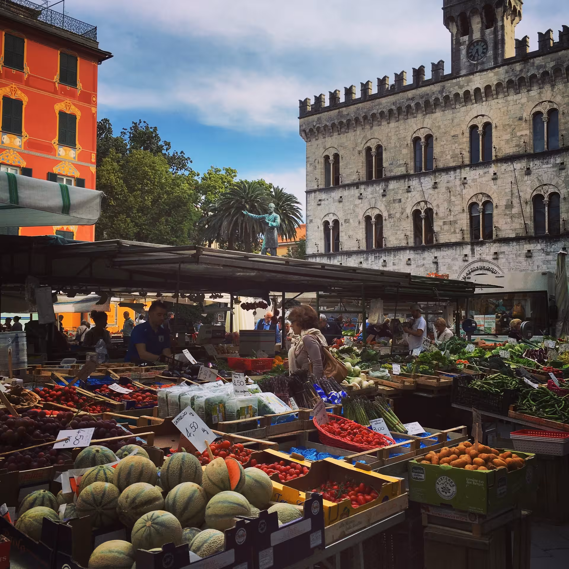 Chiavari market scene with fresh produce stalls and historic architecture, perfect for a cultural food tour experience.