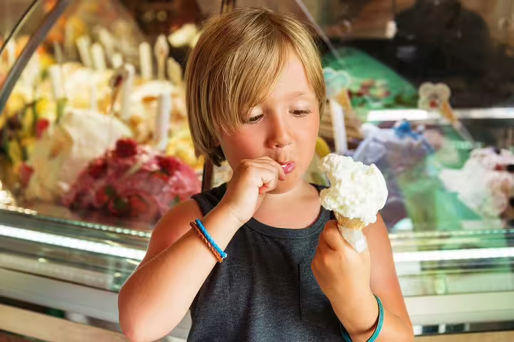 Child enjoying gelato in Rome during a family-friendly tour featuring games and local delicacies, perfect for kids.