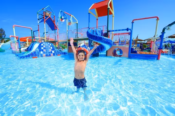 Child playing in shallow splash pool at Makadi Water World Aqua Park from Hurghada Makadi Safaga El Gouna