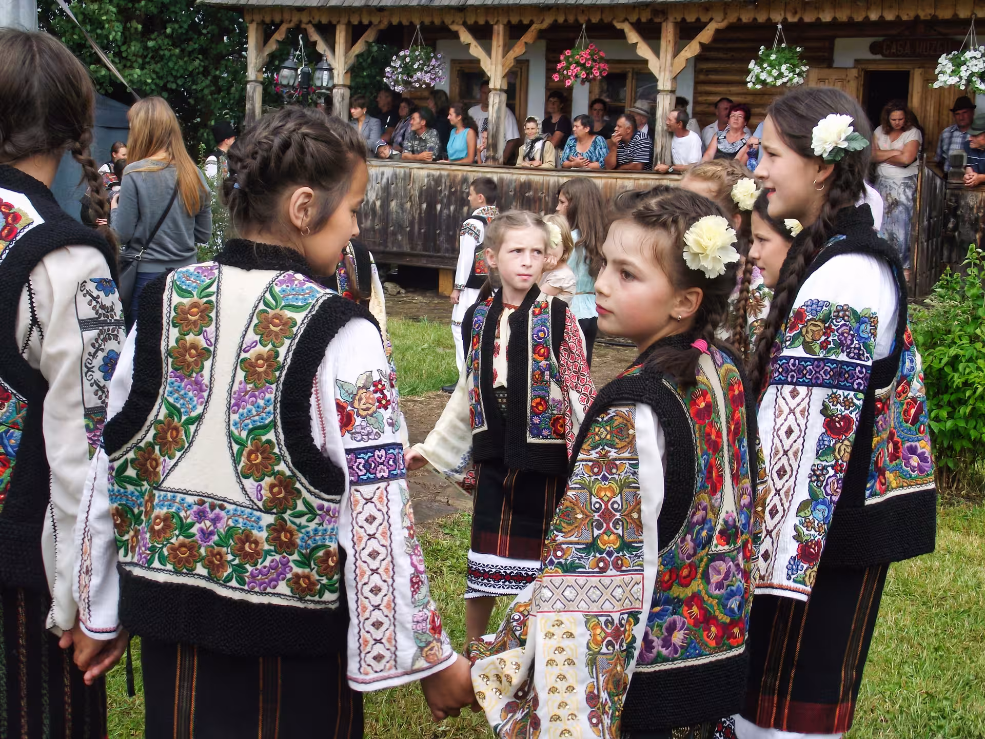 Children in colorful embroidered Romanian folk costumes at a traditional Bucovina cultural festival