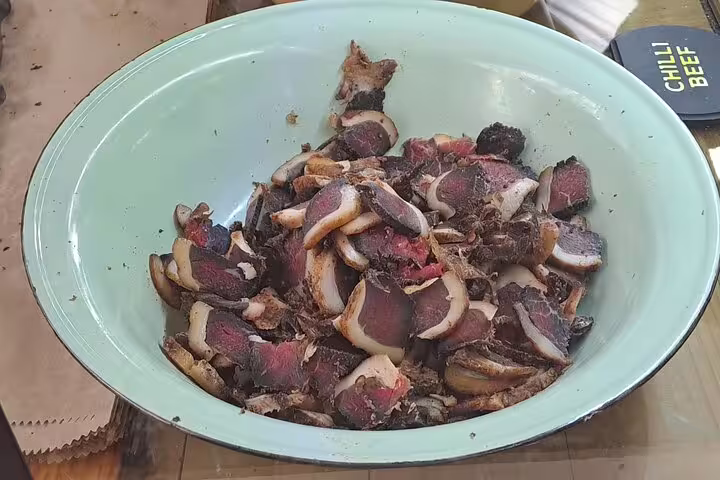 Bowl of sliced chili beef showcasing a savory specialty on a flavorful 3-hour culinary exploration tour.