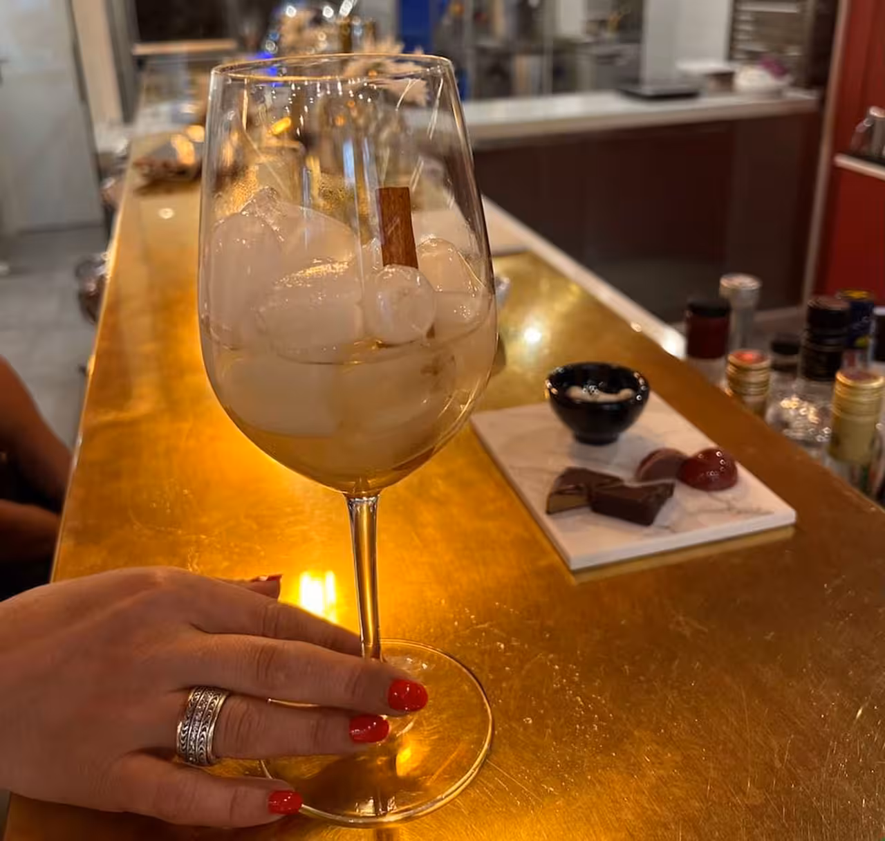 Close-up of chilled cocktail and artisan chocolates at a gourmet food tour tasting in a stylish bar