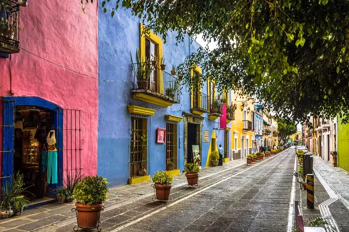 Colorful colonial buildings lining a cobblestone street in Chimalistac, Mexico City