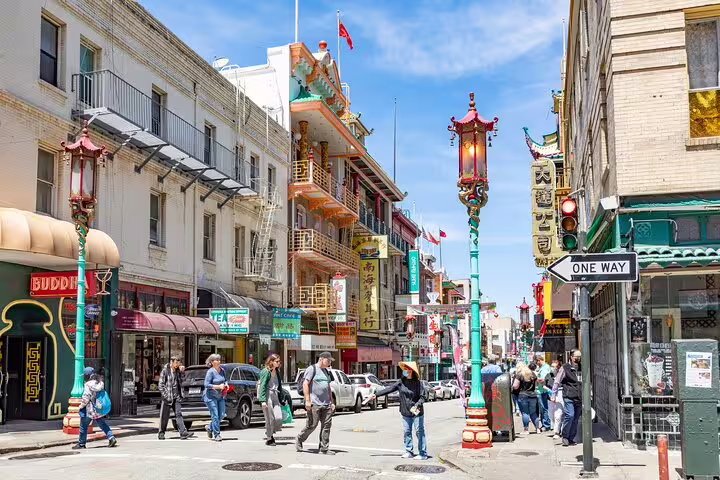 Colorful Chinatown San Francisco street with ornate lamp posts, Chinese signs, and pedestrians on Grant Avenue