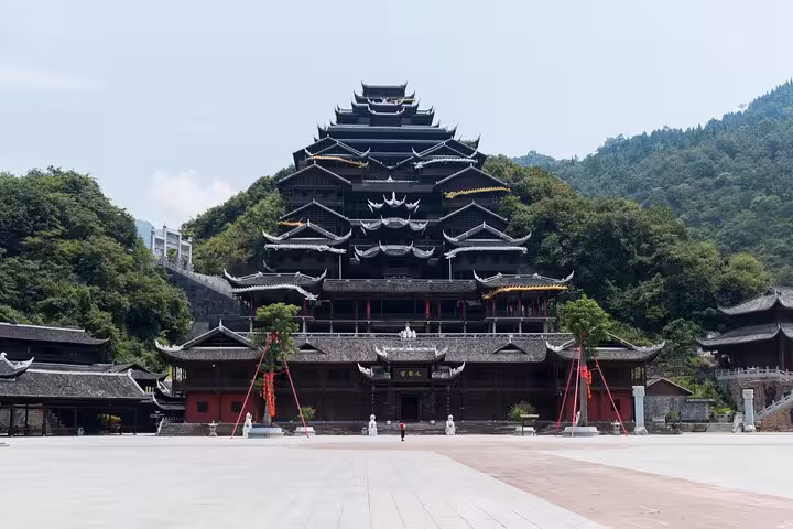 Discover the cultural heritage of Chiyou Jiuli City with its impressive traditional architecture nestled in lush greenery.