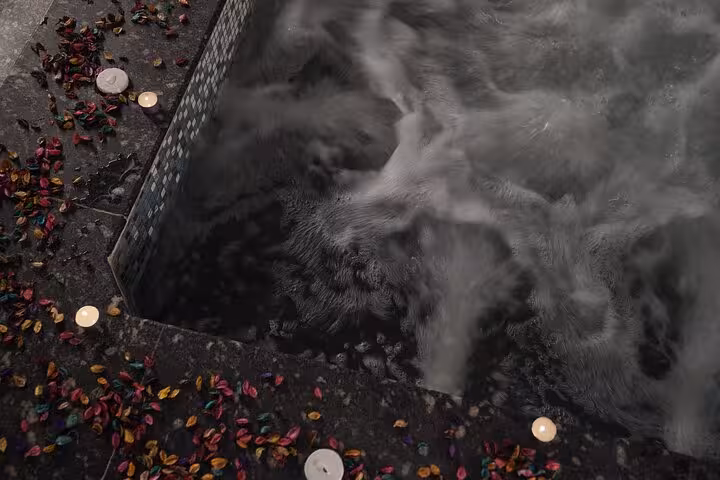 Close-up of bubbling spa jacuzzi with candles and rose petals during Chocolate Magic Bath Spa Experience in Sharm El Sheikh